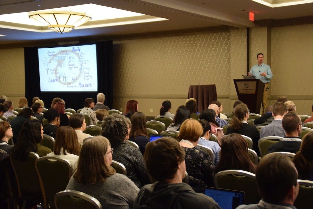 Dan speaking in front of a large audience at UXPA Boston 2019